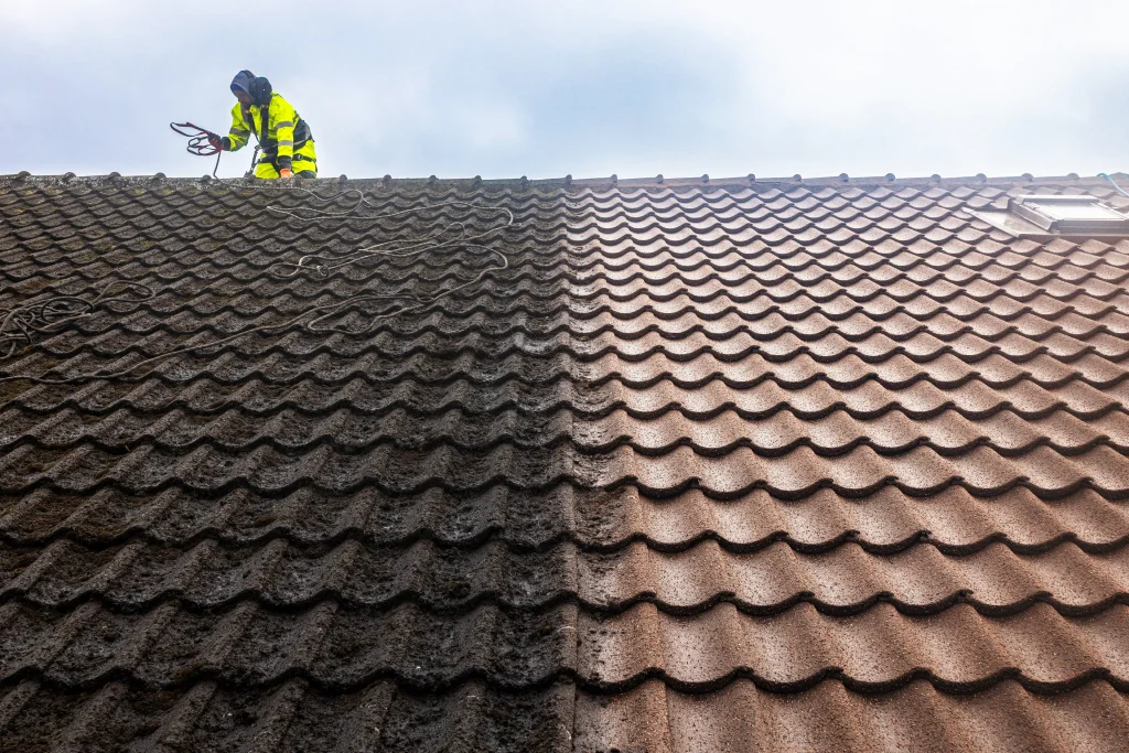 Detaljerad före- och efterbild av taktvätt i Malmö, Skåne. Bilden visar den dramatiska skillnaden mellan mörka, mossbeklädda takpannor till vänster och rena, ursprungliga rödbruna pannor till höger under pågående arbete.